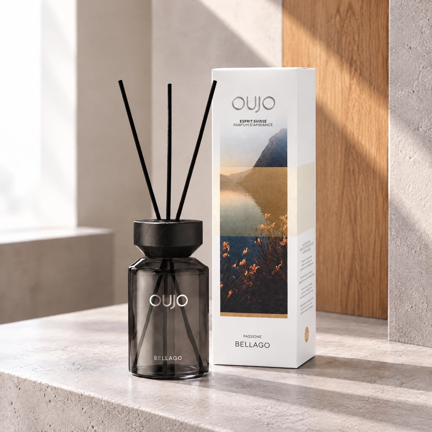 A diffuser with scent sticks and product packaging rests on a table.