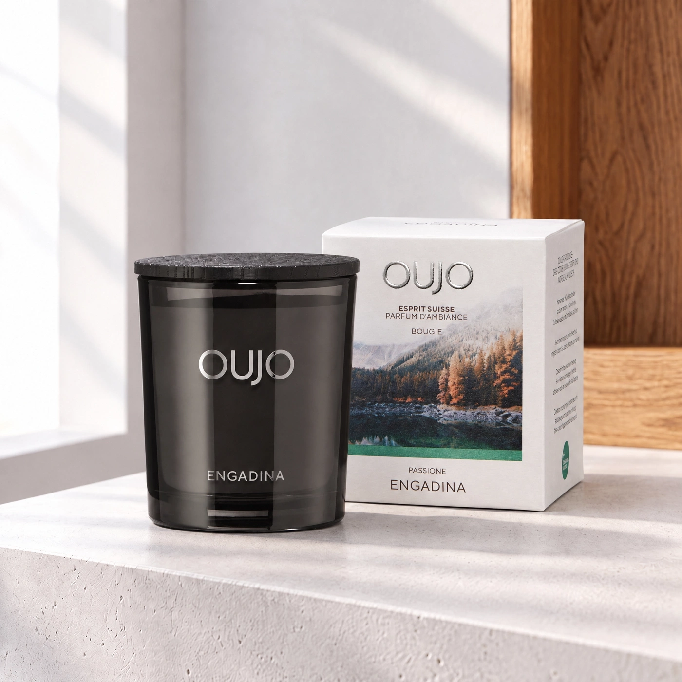 Black scented candle with lid and box featuring alpine landscape.