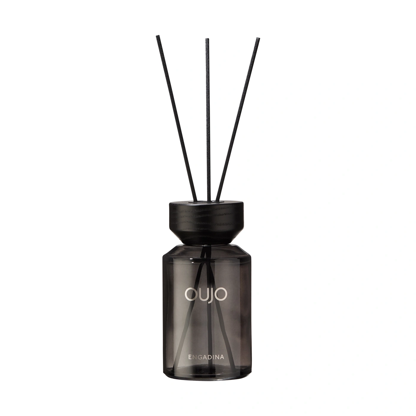 A black diffuser with three reeds stands on a white background.