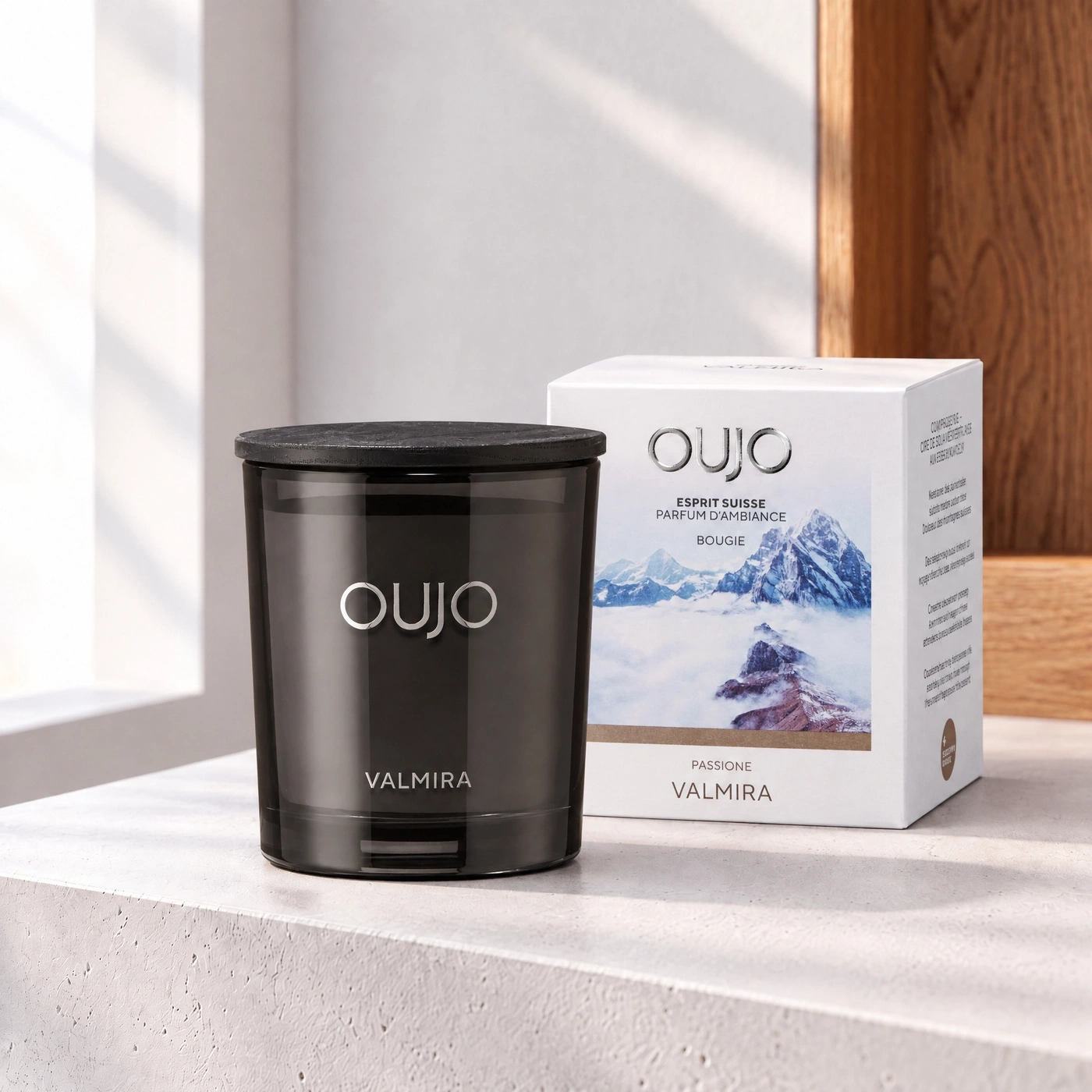 Black scented candle and packaging with mountain motif in light.