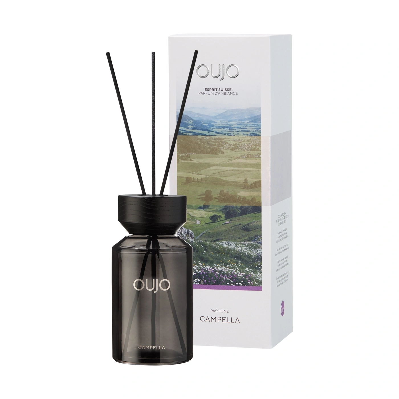 Ein Flakon mit Duftstäbchen und einer Verpackung mit Berglandschaft.