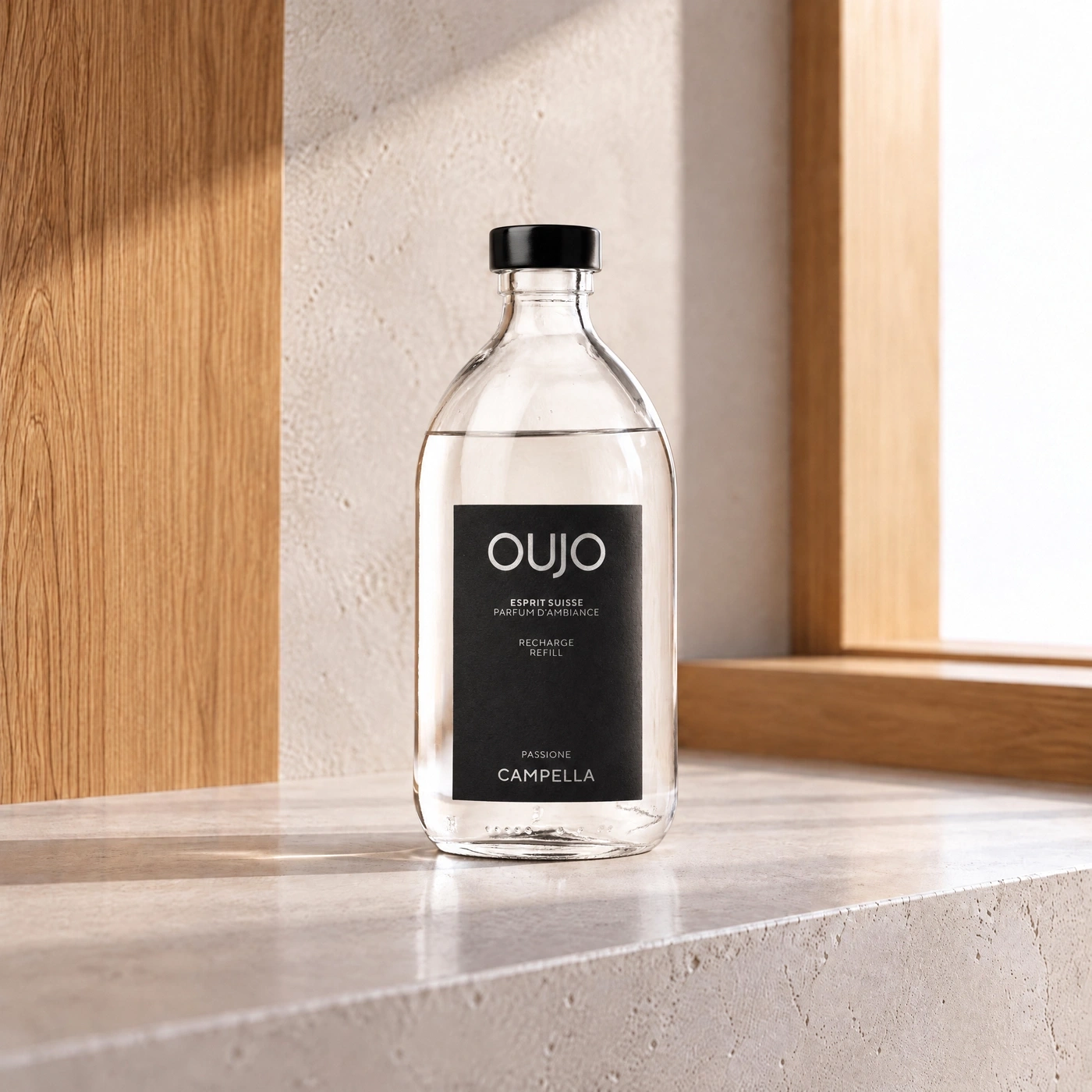 A glass bottle of scented perfume on a stone pedestal.