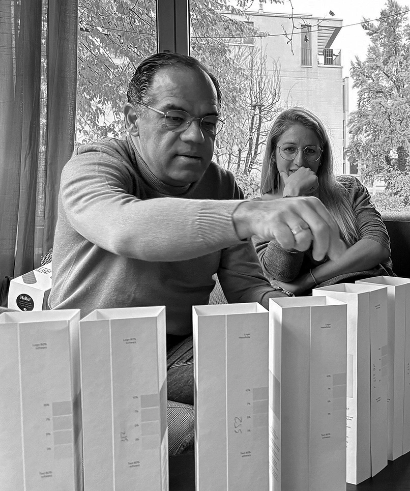 Man and woman with white packaging in front of them.